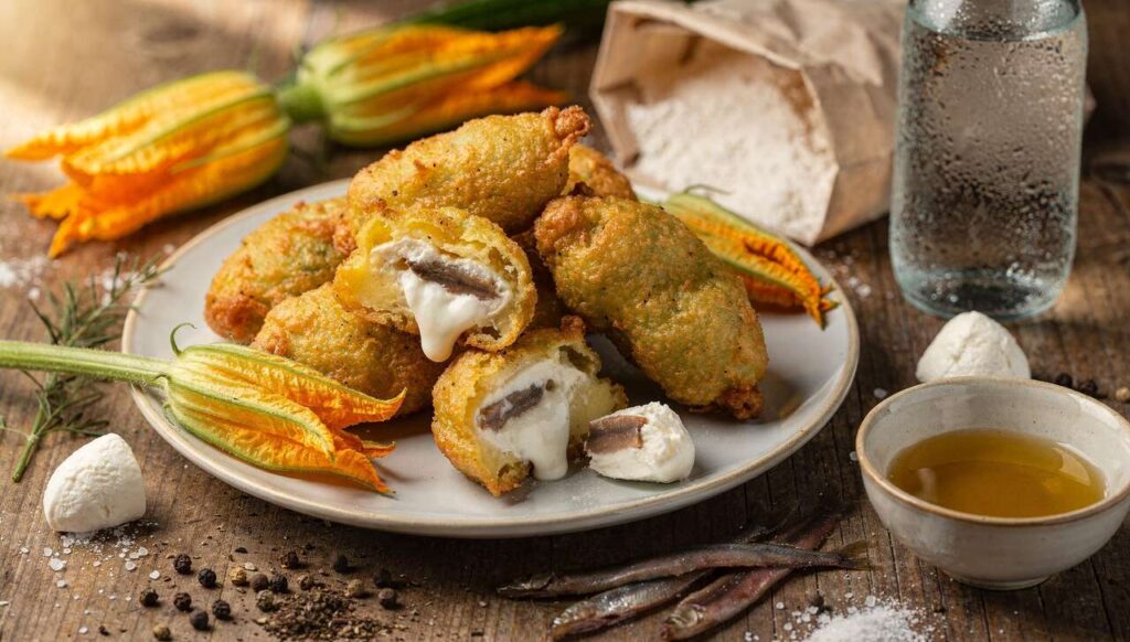 Frittelle di fiori di zucca ripiene di mozzarella e alici: croccanti e leggere al primo morso!